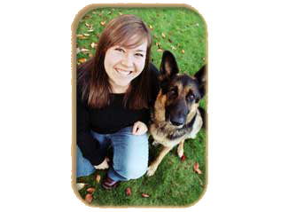 Smiling woman sitting with German Shepherd dog.