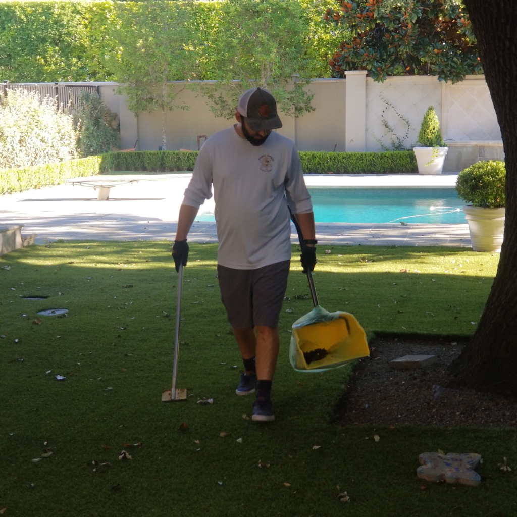 Pet waste removal technician cleaning a yard